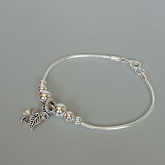 This is a sterling silver chain bracelet with beads and a leaf and four leaf clover charm. Length: 7.5 inches Width of chain: 2 mm Beads: 8/6/5 mm Leaf: 6 x 12 mm 4 leaf clover: 8 x 11mm This bracelet is made of 925 hypoallergenic sterling silver. This piece is sent in a gift box. I can include a personal message from you if needed You are welcome to contact me at... bhavnakwintra1956@gmail.com For more beautiful pieces from my shop, please browse 👇 TOE RINGS: https://www.etsy.com/your/shops/Th Silver Anklets Designs, Silver Bracelet Designs, Four Leaf Clover Charm, Pandora Bracelet Designs, Bracelet With Beads, Pretty Jewelry Necklaces, Clover Bracelet, Gold Bridal Jewellery Sets, Silver Bracelets For Women