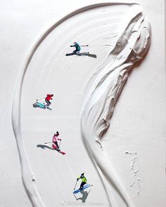 three skiers skiing down a snow covered slope with white frosting on the bottom