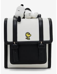 a white and black bag with a stuffed animal on top