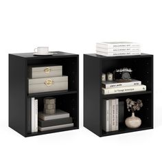 two black bookcases with books on each shelf and a camera sitting on top