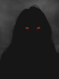 a woman with red eyes in the dark