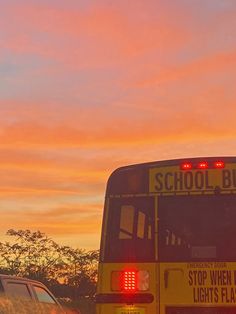 a school bus driving down the road at sunset