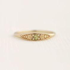 August birth ring This ring will be a very meaningful piece for those born in August . August's birthstone and birth flower are Peridot and Poppy. Greeny peridot and delicately carved poppy will shine and bloom forever. This dainty and slim signet ring is comfortable to wear all the time. This piece will be perfect gift for both to others and yourself. * Detail * Material : 14K solid gold, 18K solid gold, 925 sterling silver Color : Yellow gold, White gold or Rose gold(925 sterling silver is excluded) Stone : Natural Peridot(2.5mm) * Size * Top width : 3.7mm Shank width : 1.2mm Band depth : 2.4-0.9mm * Please check your ring size before ordering, Use this : http://www.onlineconversion.com/ring_size.htm We provide special package with some our business card, guarantee card, gift box. Please Subtle Promise Rings, August Birthstone Rings, September Birth Stone Ring, Boho Promise Ring, Engagement Rings Embedded Stone, Vintage Stone Ring, Gold Floral Ring, Simple Dainty Rings, Cute Class Rings