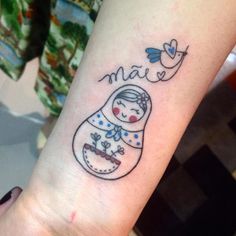 a small tattoo on the arm of a woman's wrist that says mama with a snowman