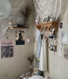 a bedroom with pictures and stuffed animals on the wall