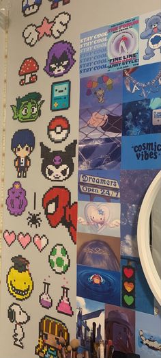 an assortment of video game stickers are on the wall next to a mirror and desk