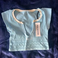 Never Worn With Tags Urban Outfitters Size Xs/S But Is Very Stretchy Seamless So U Can Wear Without A Bra Baby Blue Color Perfect For Summer Affordable Striped Tops From Urban Outfitters, Cheap Urban Outfitters Tank Top For Beach, Cheap Urban Outfitters Crop Tank Top, Cheap Stretch Crop Top By Urban Outfitters, Urban Outfitters Seamless V-neck Top, Blue Stretch Summer Tops, Seamless Light Blue Crop Top For Spring, Light Blue Seamless Summer Top, Light Blue Ribbed Summer Top