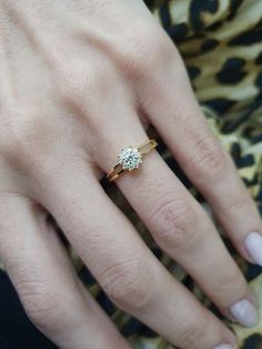 a woman's hand with a diamond ring on it