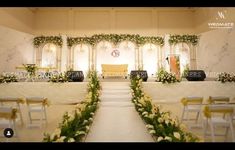 a wedding ceremony setup with white and yellow flowers