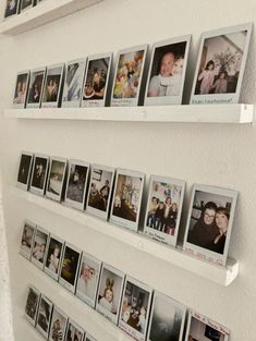 several pictures are hanging on the wall with magnets attached to each shelf and two shelves holding photos