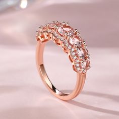 This exquisite band is crafted with seven uniquely-sized round-cut morganite stones, each one a testament to beauty and individuality. Embracing the allure of nature, delicate white stones gracefully encircle each morganite, accentuating their ethereal glow. Together, they create a harmonious blend of soft hues and brilliant sparkle, symbolizing unity and everlasting love. With its captivating design, the morganite band captures the essence of timeless sophistication. Its enchanting allure effor Rose Gold Morganite Topaz Ring, Divine Love, White Stones, Everlasting Love, White Stone, Morganite, Quality Jewelry, Round Cut, Bespoke