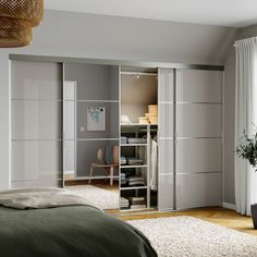 a bedroom with a bed and closets in it