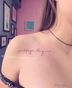 a woman with a tattoo on her shoulder that says, everything is amazing in cursive writing