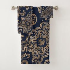 a blue and gold patterned towel hanging on a wall