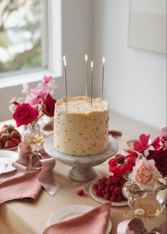 a cake with candles on it sitting on a table