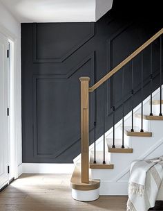 a staircase with black walls and wooden steps