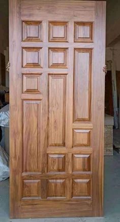 a large wooden door sitting inside of a building