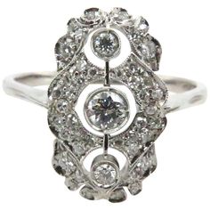 a white gold ring with diamonds in the center and an oval design on it's side