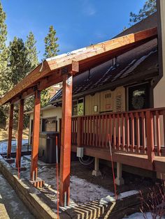 a house with wooden porchs and an attached hot tub