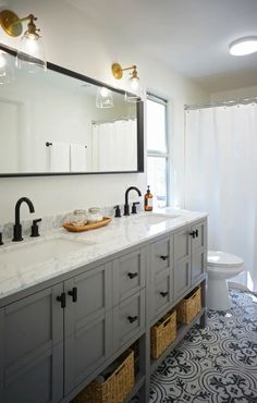 a bathroom with two sinks and a large mirror