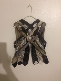 a piece of clothing hanging on a wall with ties tied to it's sides