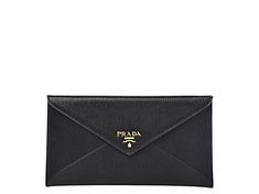 This long envelope wallet from Prada is constructed of black vitello move leather and features the Prada logo in gold hardware. It is the perfect accessory to hold your cards and bills. The leather is textured but smooth to the touch and wonderful. There are 3 credit card holders inside and one zipper pouch on the back exterior.     Model: 1MF175    Black Vitello Move leather  Gold-tone hardware  Three credit card slots  One exterior zipper pocket  Measurements: 7.75" x 1" x 4.25" (LWH)  Include Classic Business Wallets With Gold-tone Logo Plaque, Elegant Bifold Wallet With Logo, Elegant Formal Wallets With Logo, Elegant Business Wallets With Logo, Elegant Business Wallet With Logo, Elegant Wallets With Logo, Elegant Everyday Wallets With Logo, Elegant Travel Wallet With Logo, Long Envelope