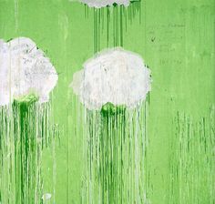 an image of two white clouds with green paint dripping from them on a green wall