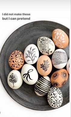 there are many different types of eggs in the black and white plate on the table