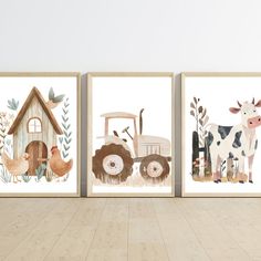 three farm animals are hanging on the wall next to each other in front of a wooden floor