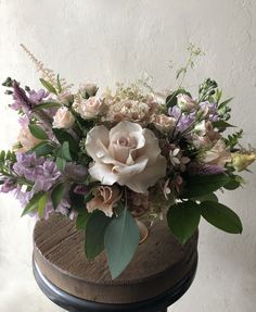 a bouquet of flowers sitting on top of a wooden table