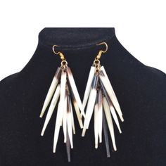 African porcupine quill earrings. This Porcupine quill earrings is made from genuine African porcupine. This porcupine quill earrings has a unique eye-catching layered design with a natural mix of brown and white shades. No animals were harmed for their porcupine quills. These are NATURALLY shed porcupine quills from Kenya porcupines and collected without any harm to the porcupine. Porcupine Quill necklace are also available for matching pieces.   - Length (including hook) - 3.5inches/9cms.   For matching necklace within the store, check out the link below https://www.etsy.com/listing/708493395/african-porcupine-quill-tribal-necklace?ref=shop_home_active_59&frs=1&sca=1 Porcupine Quill Porcupine Earrings African Porcupine Nature Jewelry Porcupine Quill Earrings, Quill Earrings, Fulani Earrings, African Inspired Jewelry, Porcupine Quills, African Print Clothing, Jewelry Nature, White Shades, Lucky Elephant