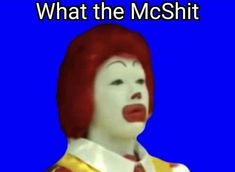 a woman with red hair and white makeup is wearing a clown mask, which reads what the mcoshit?