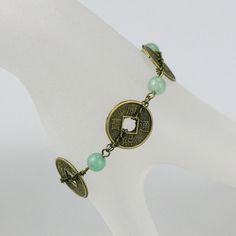 "The link bracelet is handmade using semi precious stone jade and vintage coin. Free US shipping For matching earrings, please go to: https://www.etsy.com/listing/122109597/jade-and-antique-coin-hoop-earrings For matching necklace, please go to: https://www.etsy.com/listing/197905450/antique-coin-charm-jade-collar-necklace?ref=shop_home_active_1 Customers who purchased this item said: \"I bought a number of items from this shop including earrings and a necklace. Each one is exquisitely made, uni Antique Nickel-free Bracelet As Gift, Nickel-free Coin-shaped Bracelets As Gifts, Vintage Jade Bracelets, Vintage Jade Round Bracelets, Vintage Round Jade Bracelets, Vintage Jade Jewelry For Jewelry Making, Antique Jade Jewelry As A Gift, Antique Jade Jewelry For Gift, Antique Charm Bracelet