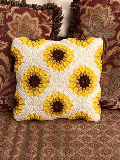 a decorative pillow with sunflowers on it