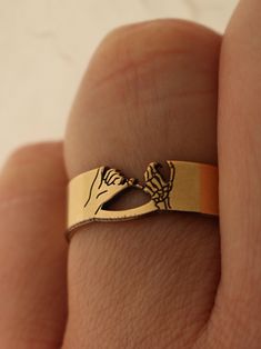 "Copy and paste into your browser, get 15% off ➔ https://bit.ly/VD15OFF Looking for the perfect promise ring for your best friend or partner? This design features a pinky swear with one skeleton hand and one regular hand, with a unique cutout design, representing the promise the ring creates. DETAILS: -One Ring -Ring is 14/20 Gold Filled -6mm in thickness You will receive one skeleton pinky promise ring. **Every item is handmade, this means that each will be unique and may not look EXACTLY like the picture, but it will look very similar ➡ORDER PROBLEMS If there are any problems with your order please contact me, my goal is for you to be happy with your products and I will do what I can to help! ➡BULK ORDERS I gladly make bulk orders! For every bulk order of 15+, there is a special discount Pinky Promise Rings For Couples, Gold Skull Ring Halloween Gift, Gold Skull Ring For Halloween Gift, Pinky Promise Ring, Gold Skeleton, Pinky Swear, Friendship Ring, Ring Everyday, Promise Rings For Couples