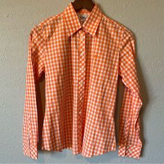 Lily Pulitzer Button Down Blouse Checkered Pattern Long Sleeve Size: 4 Color: Orange And White Condition: Previously Owned And In Excellent Condition. Looks Brand New & Like It Hasn’t Been Worn. Typically Can Ship The Next Day Offers Welcomed Smoke Free/Pet Free Home Bundle And Save Please Feel Free To Ask Questions Thank You For Stopping By My Closet! Happy Poshing! Classic Orange Tops For Spring, Spring Orange Shirt With Button Closure, Orange Shirt With Button Closure For Spring, Classic Orange Tops With Buttons, Classic Orange Buttoned Top, Fitted Spring Shirt With Snap Buttons, Orange Cotton Blouse With Button Closure, Fitted Shirt With Snap Buttons For Spring, Fitted Shirt With Back Button Closure For Spring