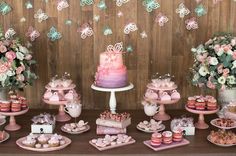 a table topped with lots of cakes and desserts