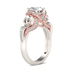 a white and pink gold ring with two diamonds on the band, set in 18k rose gold