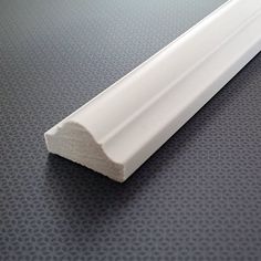 an image of a close up view of a white plastic tube on a gray surface