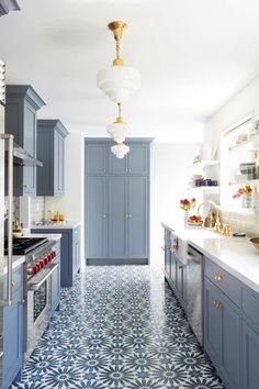 a kitchen with blue cabinets and white counter tops