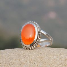 Natural Carnelian Gemstone Silver Ring 925 Sterling Silver Ring Statement Ring Handmade Ring Carnelian Silver Jewelry Product Details Type : Carnelian Gemstone Rings Material : 925 Sterling Silver Finish : High Polish Stamp : 925 Gender : Women Occassion : Anniversary, Engagement, Gift, Party, Wedding Stone Details Stone Name: Natural Carnelian  Stone Shape : Oval Cabochon Additional Details Brand : Mysteriousgemsshop Place of Origin : Jaipur, Rajasthan, India Disclaimer 1: Size of the actual it Red Gemstone Ring, Wedding Stone, Carnelian Stone, Red Gemstones, Rajasthan India, Jaipur Rajasthan, Oval Cabochon, Ring Handmade, Statement Ring