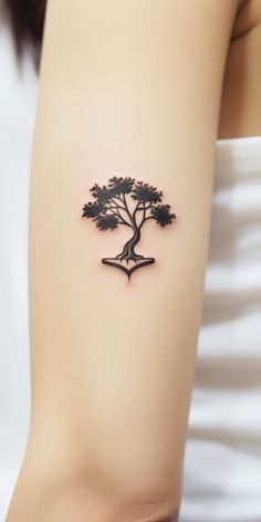 A tattoo showcasing a tree in a minimalistic style, representing the pure and unfiltered bond between humans and nature. Minimal Tree Tattoo, Spirit Of The Forest, Chakra Tattoo, Flash Tattoo Designs, Book Tattoo