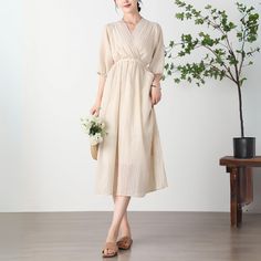 "Cool and comfortable for hot summer days, this beige dress is elegant and stylish. It is a wonderful wardrobe staple that's a timeless classic you'll wear again and again.  All our items are Tailored and Handmade and Made to Order ,I can make Any Size . I design new styles every week, please collect my store. I believe that you will meet your favorite styles. ★★FEATURES 80% polyester fiber, 20% cotton Has lining Two side pockets Puff sleeves, half sleeves V neck dress With belt Midi dress Loose dress Plus size dress Beige dress Perfect for Spring, Summer ★★Size Chart: ❤ Size chart is the garment's measurements, Not body measurements . One size: Length: 117cm/46.06\", Bust: 104cm/40.94\", Shoulder: 38cm/14.96\", Sleeve: 36/14.17'' ★★ Bespoke Order Service If you Request other color Request Beige V-neck Sundress For Day Out, Beige V-neck Dress For Summer Brunch, V-neck Maxi Dress For Summer Daywear, Maxi Length V-neck Dress For Summer Daywear, Summer V-neck Maxi Dress For Daywear, Summer Maxi Length V-neck Dress For Daywear, Beige V-neck Dress For Summer, Elegant V-neck Sundress For Summer, Beige V-neck Sundress Maxi Dress