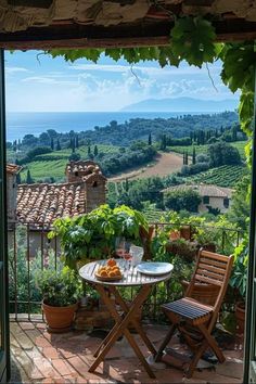 an outdoor table and chairs on a patio overlooking the countryside