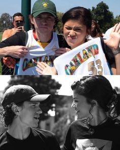 two people are holding up a sign and one is wearing a baseball cap with the number 55 on it