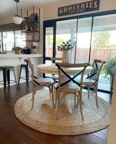 a dining room table with four chairs around it