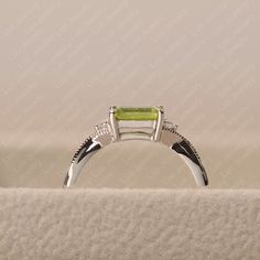 Emerald Cut Peridot Ring For May Birthstone, Rectangular Sterling Silver Emerald Ring For Wedding, Elegant Peridot Emerald Promise Ring, Rectangular Emerald Ring In Sterling Silver For Wedding, Wedding Ring With Emerald Cut Peridot, Emerald Cut Peridot Ring In Green, Emerald Cut Peridot Green Ring, Green Emerald Cut Peridot Ring, Emerald Cut Peridot Birthstone Ring