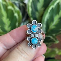 A smaller version of my double flower ring.  This cutie has two Morenci Turquosie cabs in a rustic flower setting.  She has been oxidized to bring out the details and give her a vintage feel. Measurements:  31mm x 17mm Ring Size:  8.25 Turquoise is connected to the healing energy of water, the life-giving element that sustains the planet and the origins of life itself. This energy of renewal and rejuvenation is what gives the turquoise crystal meaning. It has a unique ability to support healing intentions and overall well-being. The water-like qualities of the turquoise stone also guide you to a state of calm and tranquility, which can aid in stress-relief and the elimination of negative energies. In this way, you can also use the turquoise healing properties for energetic protection and s Unique Turquoise Flower Jewelry, Adjustable Bohemian Blue Flower Ring, Bohemian Sterling Silver Flower Ring, Adjustable Turquoise Flower Ring Gift, Turquoise Healing Properties, Flower Setting, Morenci Turquoise, Rustic Rings, Jewelry Nature