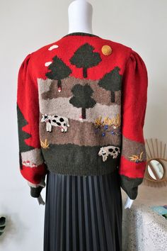 One of a kind True Vintage handmade cardigan from Austrian designer trachten label Ortrud Rainer. Superb quality wool knit with a beautiful hilly countryside scenery, embroidery and intarsia allover. Cows, trees, mushrooms, flowers, crop bundles, all above the quirky scenery the sun is shining and a few clouds in the sky - it is harvest season. Beautiful puff sleeves, authentic horn buttons. Ribbed cuffs and waistband. Contrasting trims, 'Rainer' label embroidery on the left clavicle. Hand knit Winter Retro Embroidered Cardigan, Vintage Wool Hand-knitted Cardigan, Retro Embroidered Winter Cardigan, Handmade Vintage Winter Cardigan, Handmade Vintage Cardigan For Winter, Retro Embroidered Cardigan For Winter, Retro Embroidered Sweater For Fall, Retro Embroidered Fall Sweater, Vintage Embroidered Fall Sweater