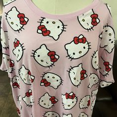 a pink shirt with hello kitty on it